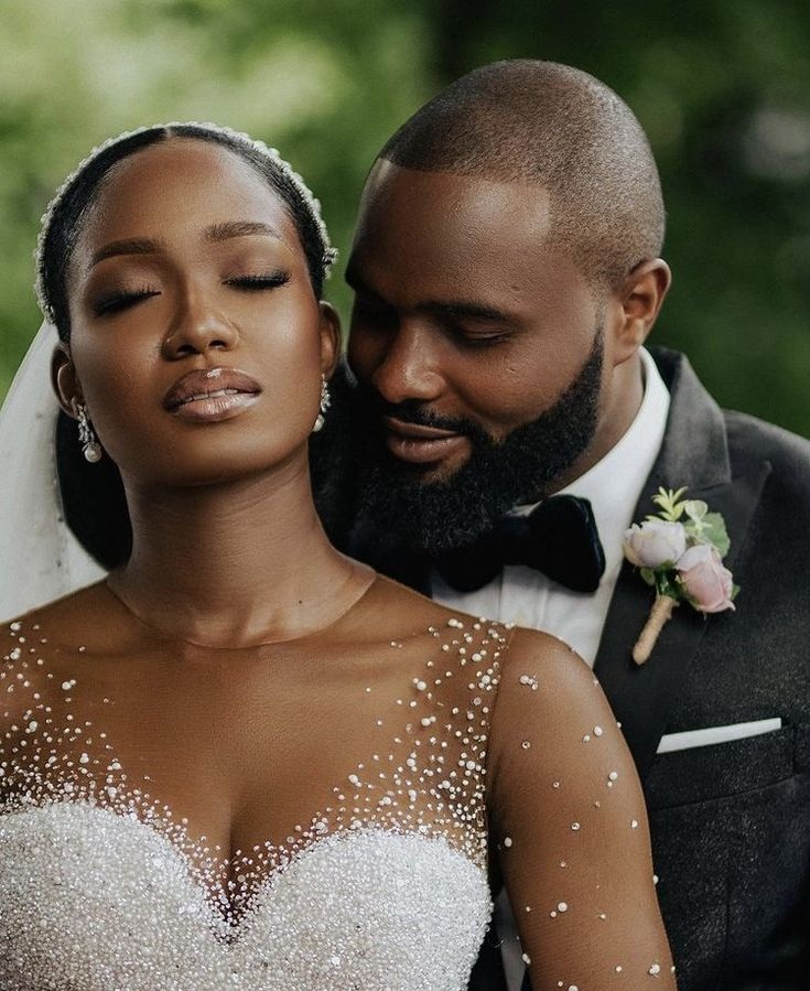 A groom hugging her bride from behind in an intimate way