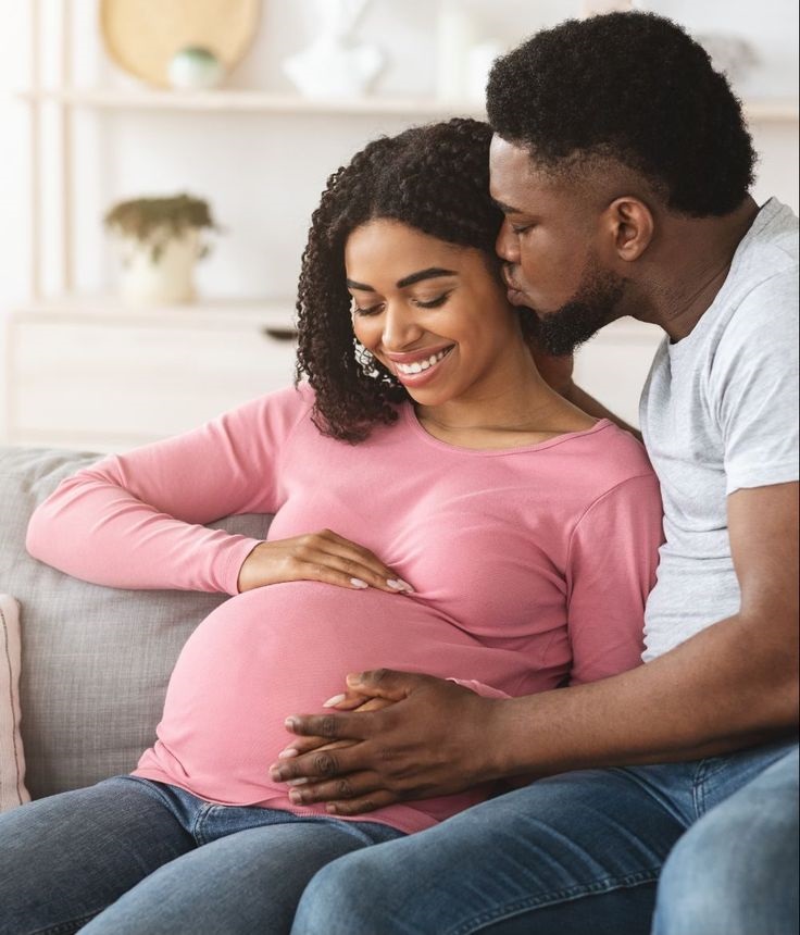 A pregnant woman and her husband.jpg