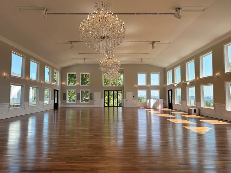 An empty hall with chandeliers hanging up