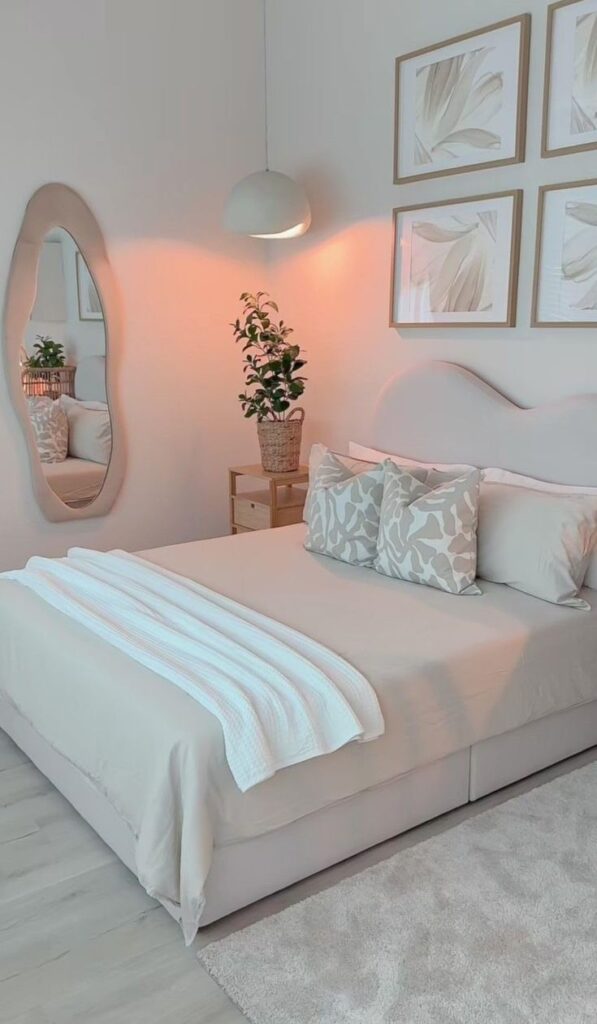 Beautifully arranged bedroom with a neatly made bed, decorative rug, and stylish mirror.