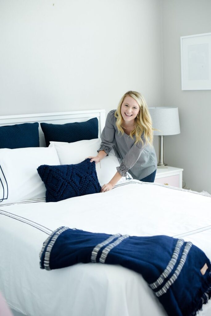 A woman dressing her bed