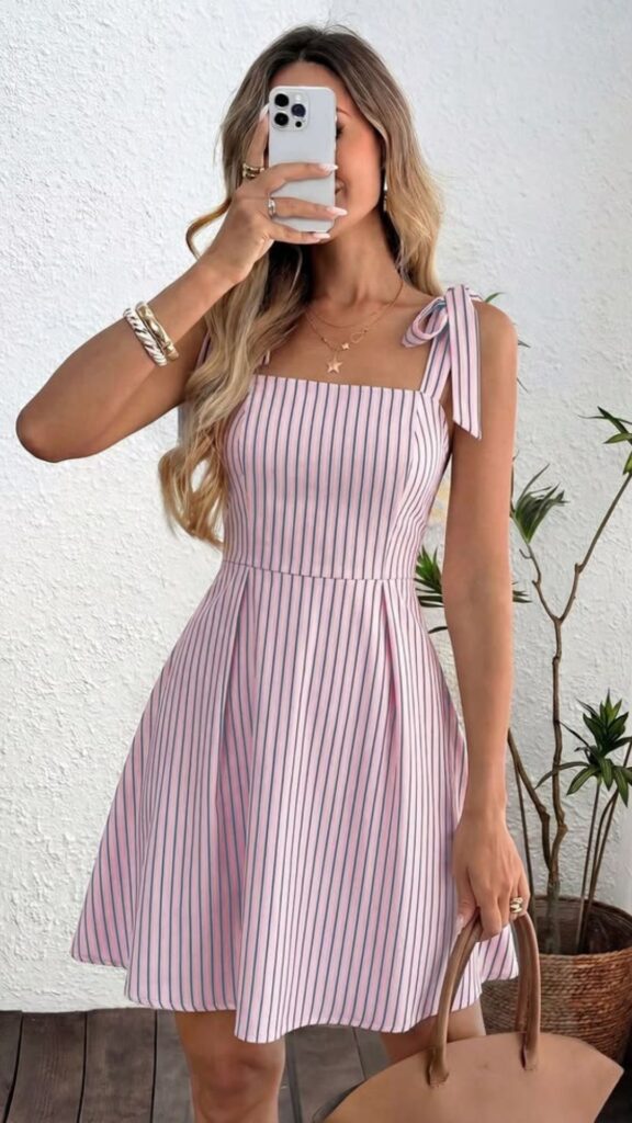 A petite fashion guide - a petite woman wearing a dress with vertical stripes