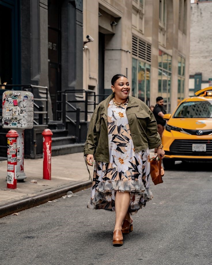 Confident plus-size woman walking stylishly down a city street