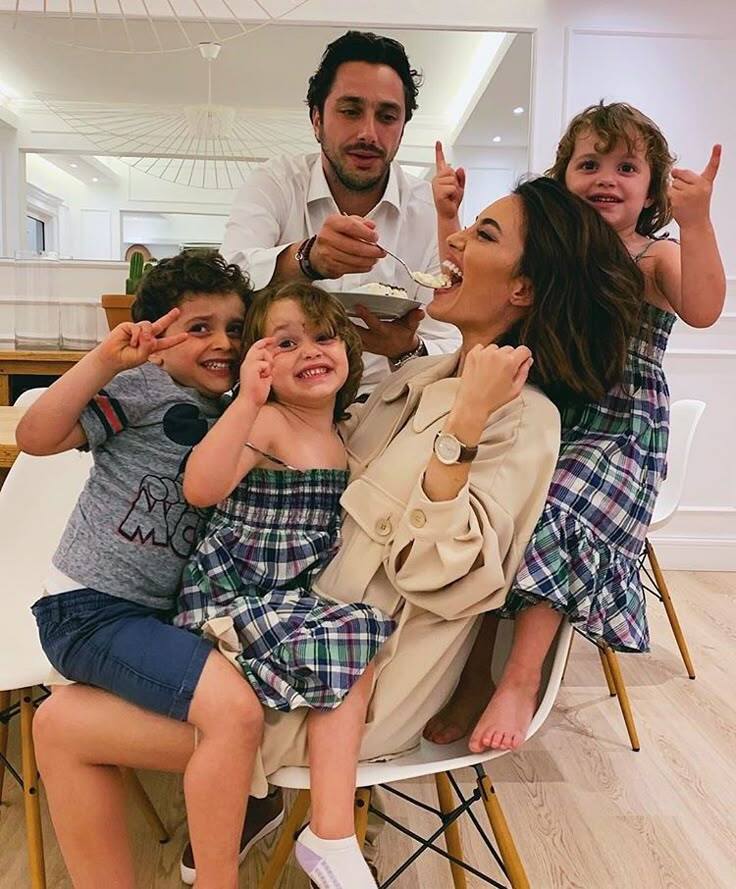 A photo of a happy family of 4 having fun and creating memories