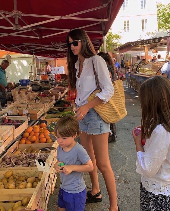 photo of a mom in the market with her children