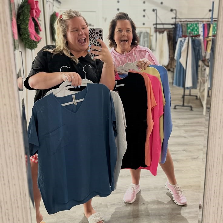 Plus-size women shopping for clothes in a fashion boutique