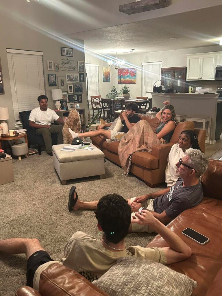 six people chatting in sitting room