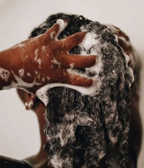 Wash day routine for 4C hair showing gentle cleansing of the scalp and strands