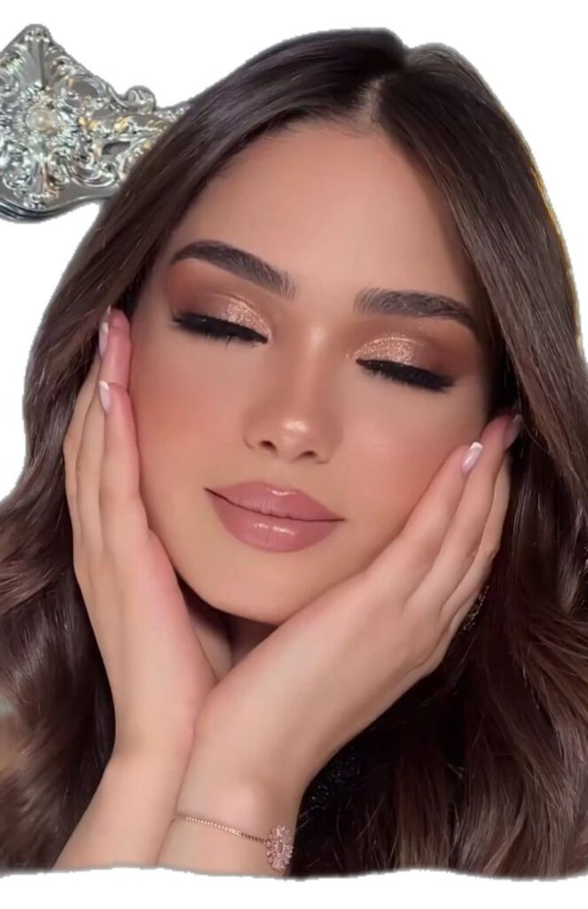 Woman with softly blended champagne eyeshadow, defined brows, long lashes, glowing skin, and nude pink lips, creating an elegant bridal makeup look with closed eyes.