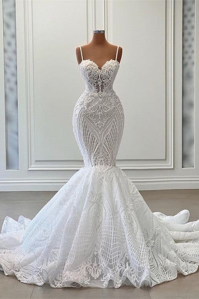 A charming sleeveless spaghetti hand wedding gown