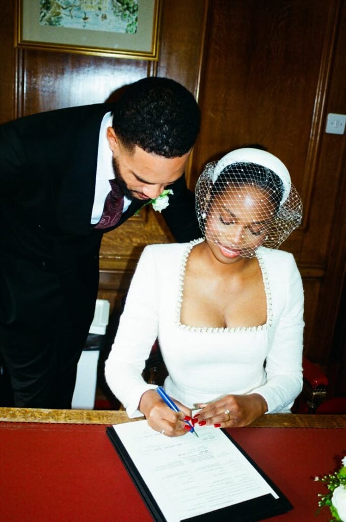 A couple signing a marriage certificate