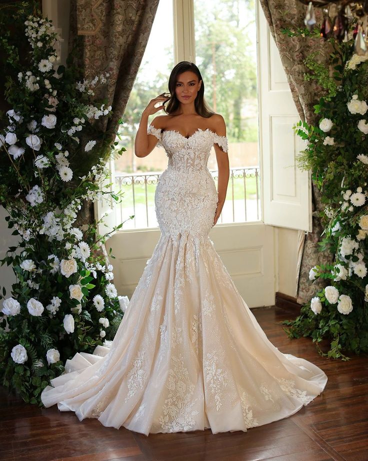 A bride on a fit and flare off-shoulder  wedding dress
