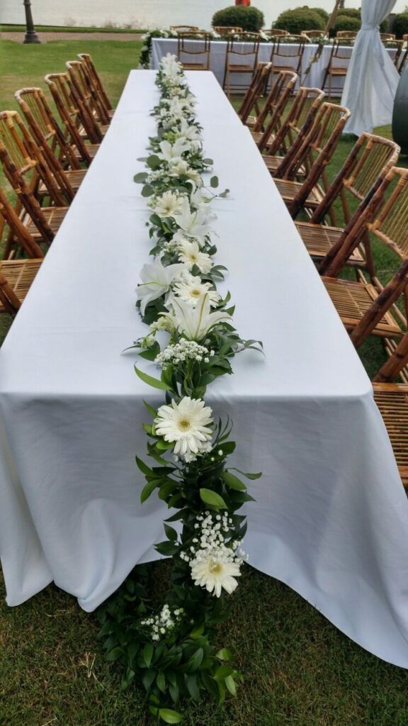 Fresh greenery running along reception table