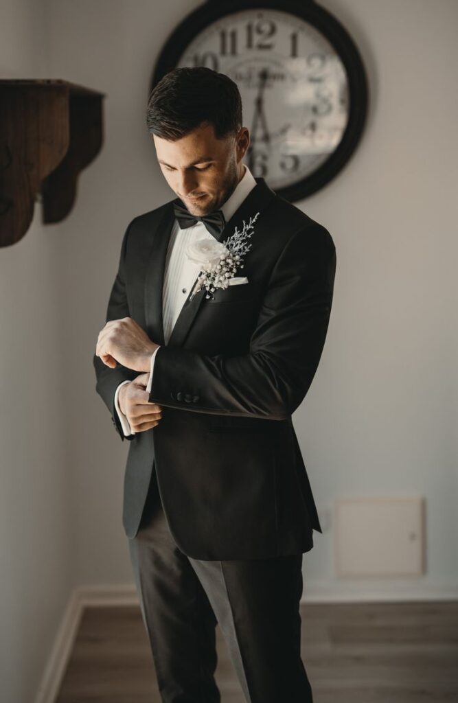 A groom getting ready for his wedding dressed in suit
