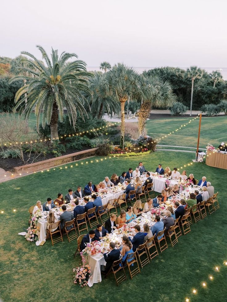 Guests seated in an outdoor decorated space for a wedding reception
