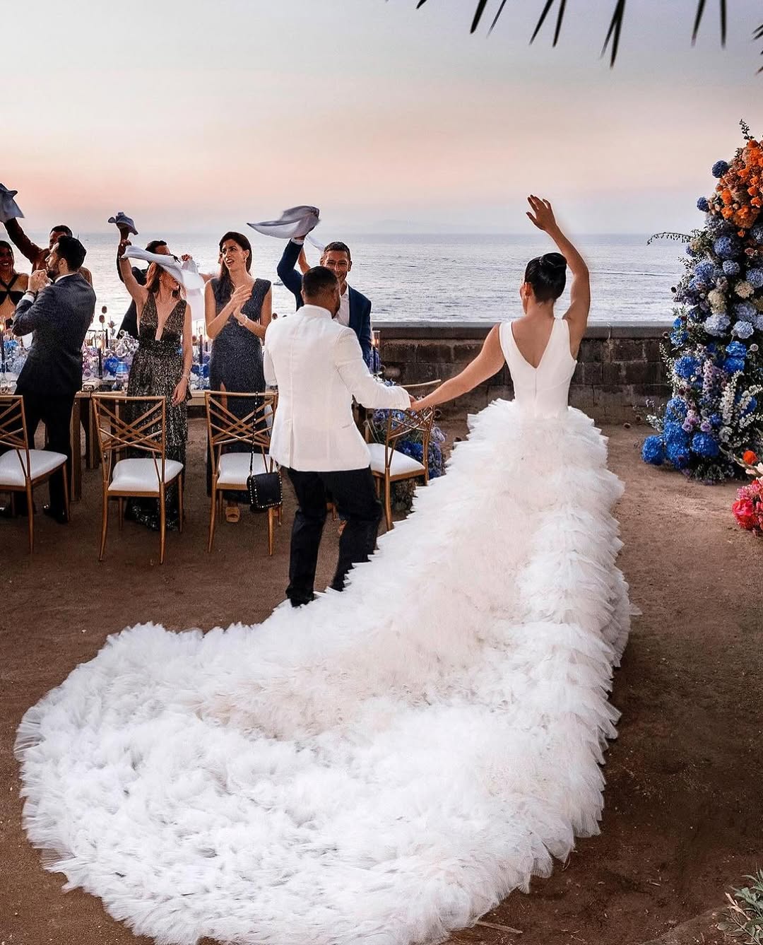 A happy couple on their wedding day rejoicing with their guests