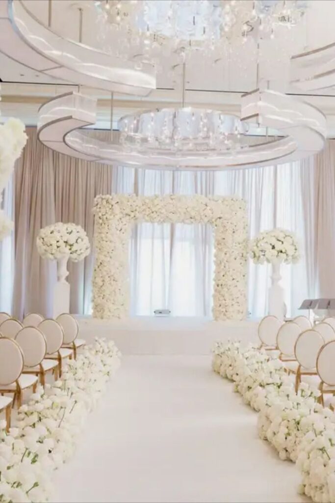 A timeless and elegant all-white wedding featuring breathtaking white florals, a stunning monochromatic ceremony, and a glamorous ballroom reception