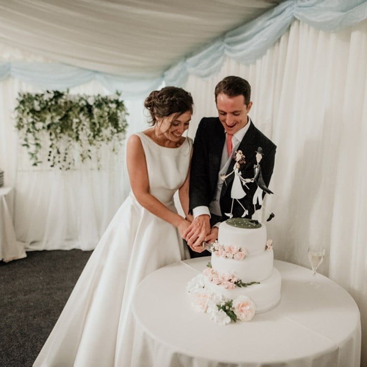 Couple cutting their wedding cake