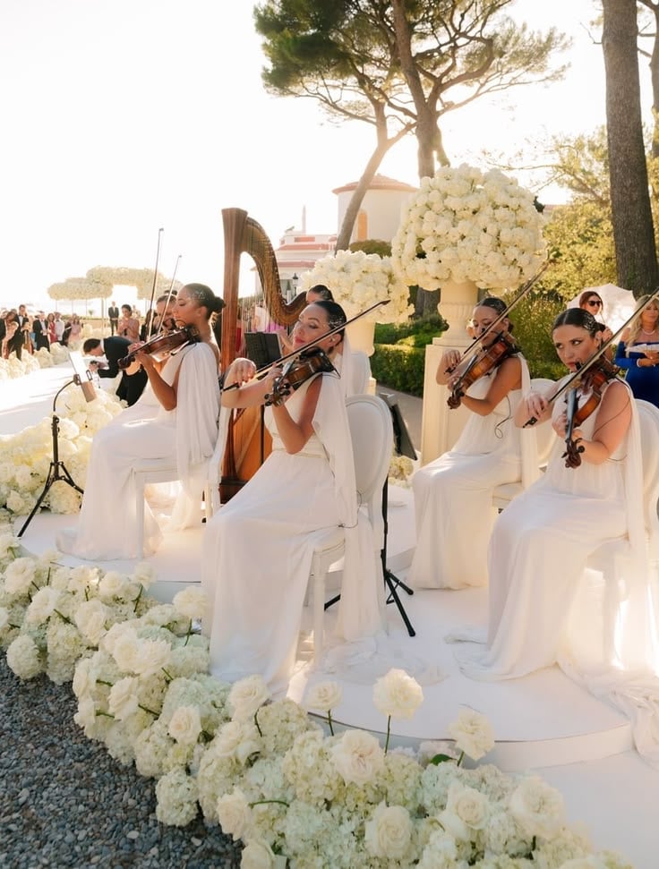 Violists performing in an outdoor wedding reception
