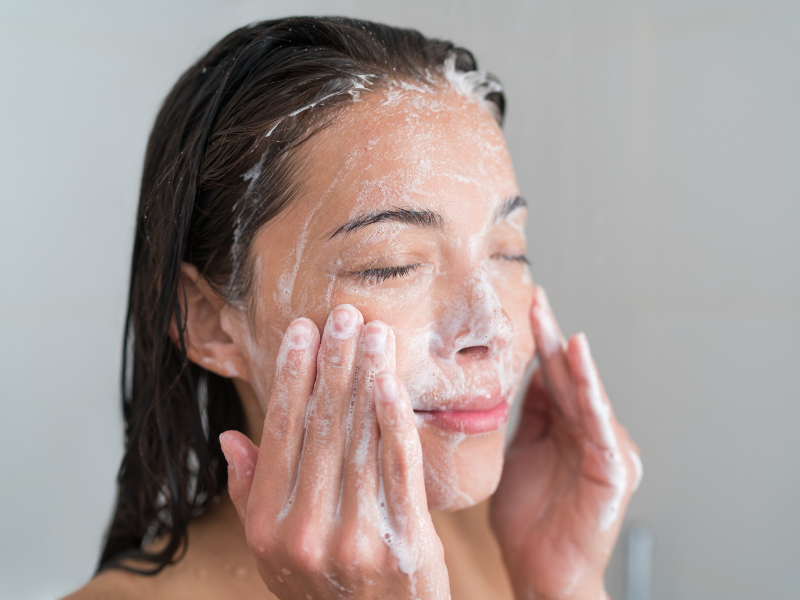  A woman in the bathroom washing her face